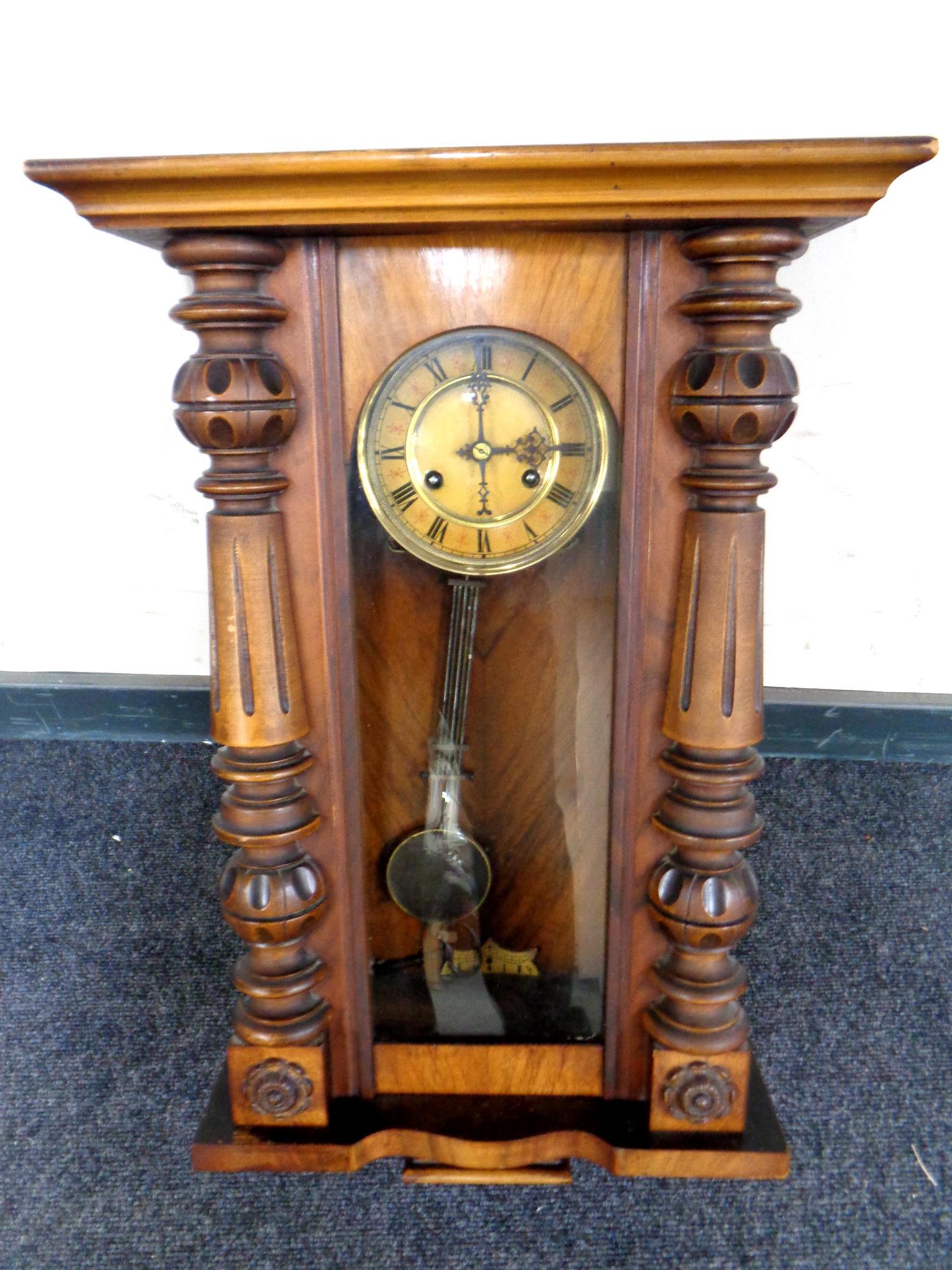 An Edwardian eight day wall clock with pendulum and key