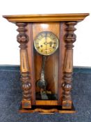 An Edwardian eight day wall clock with pendulum and key