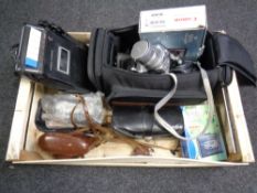 A crate containing camera bags and digital cameras by Fujifilm, Canon and Finepix, vintage cameras,