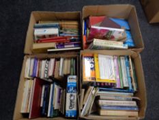 Four boxes containing a large quantity of hardback and softback books,