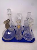 A tray containing six assorted cut glass and lead crystal decanters