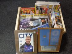 A box containing Land Rover International magazines together with a small quantity of Man City