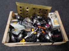 A crate containing brewery items to include a brass Stella Artois drip tray, Optics bar mats,