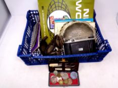 A basket containing coin collector's and stamp collector's albums, postcards, coin yearbooks,