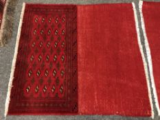 An eastern fringed cushion cover on red ground,