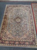 A Next machine made Persian design carpet on blue ground,