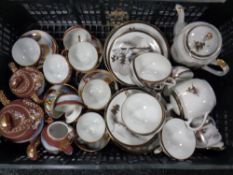 A crate containing two Japanese eggshell tea services