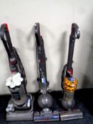 A Dyson DC 50 upright ball vacuum together with a Dyson DC 33 cylinder vacuum and a further part