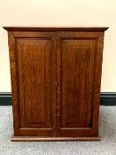 An Edwardian oak double door cabinet, width 54 cm.