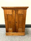 An early twentieth century pine double door cabinet, the panels marked 'H De Cabanas' , width 46 cm.