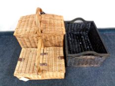 Two wicker picnic baskets containing plastic picnic ware together with a further wood and wicker