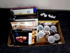 A box containing Elvis Presley memorabilia to include mugs,