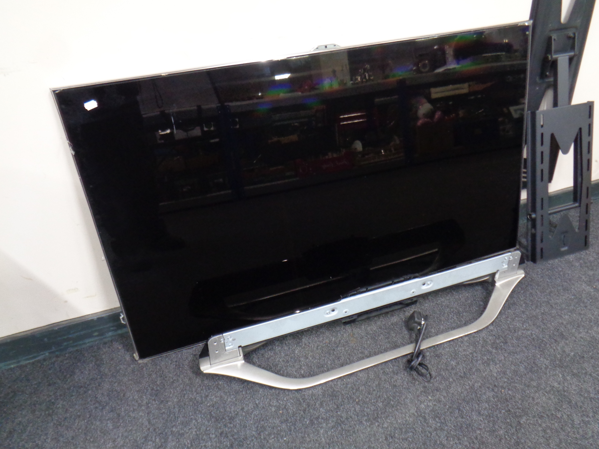 A Samsung 54'' LED picture frame TV with table stand,