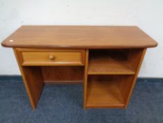 A mid 20th century teak G Plan dressing table fitted shelves and a drawer with stool,