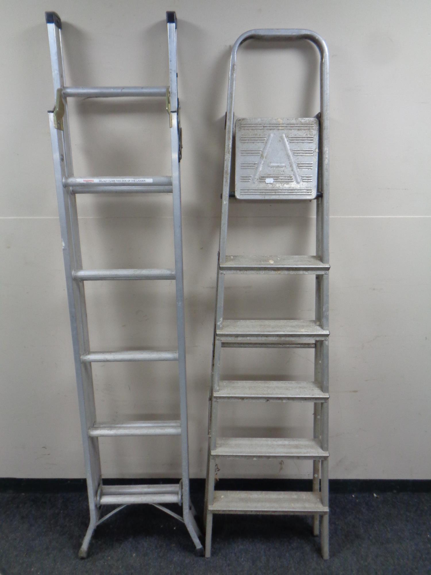 An Abru three way folding aluminium ladder together with a further set of aluminium folding steps