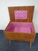 A mid 20th century teak sewing box fitted a drawer on raised legs