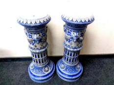 A pair of 19th century Westerwald style glazed pottery jardiniere stands decorated with lion masks