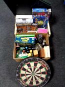 Two boxes containing Trivial Pursuit games, books, dartboard, poker table,