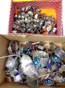Two boxes containing a quantity of Asian white metal bracelets and rings