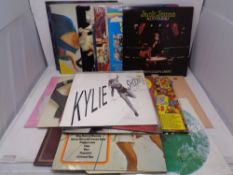 A box containing vinyl LPs and seven inch singles to include compilations, Kylie Minogue,