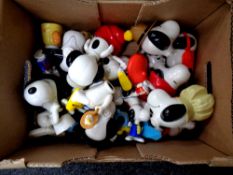 A large collection of Snoopy collectable plastic toys.