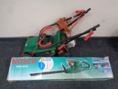 A Bosch electric hedge trimmer together with a Qualcast electric lawn mower