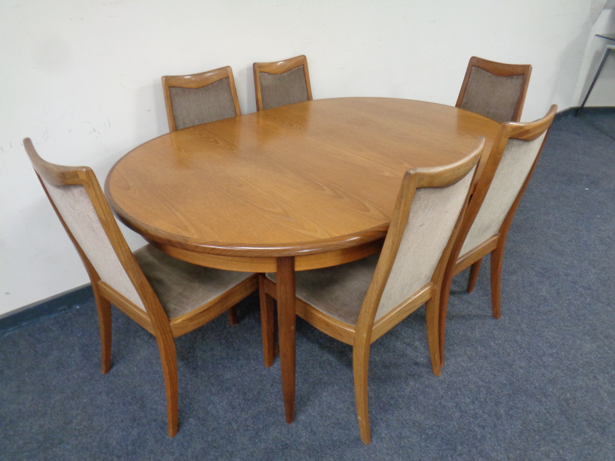 A mid 20th century teak G Plan oval extending dining table,