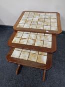 A set of three mid 20th century teak G Plan tile topped tables