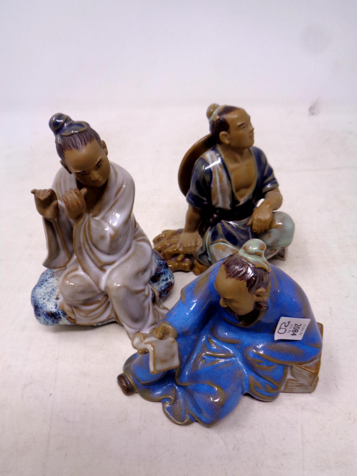 Three pottery Chinese figures of seated gentlemen