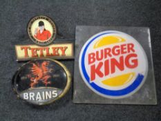 A cast iron Brains pub advertising plaque together with a further Tetley's plaque and a perspex