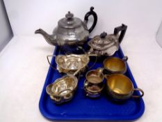 A tray containing a three piece silver plated tea service together with four further pieces of