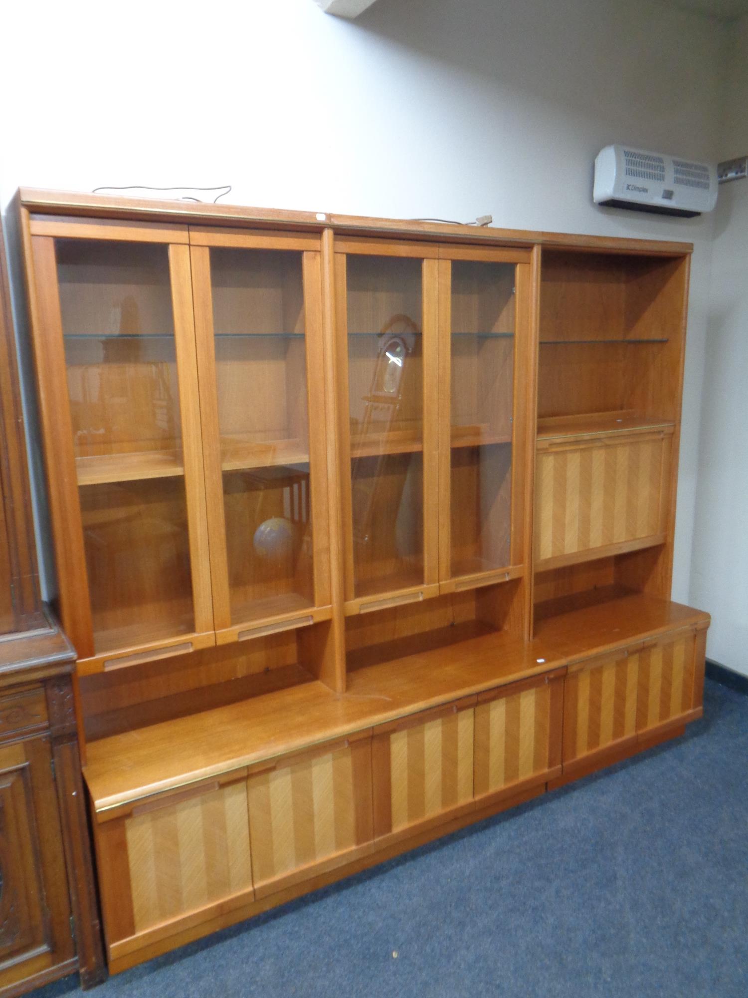 A mid 20th century teak G Plan triple section bureau bookcase fitted six cupboards beneath