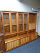 A mid 20th century teak G Plan triple section bureau bookcase fitted six cupboards beneath