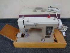 A New Home electric sewing machine in case