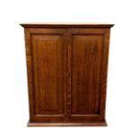 An Edwardian oak double door cabinet, width 54 cm.