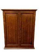 An Edwardian oak double door cabinet, width 54 cm.