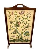 An early twentieth century oak folding table, with embroidered floral top with glass covering,