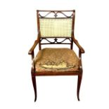A late Victorian inlaid mahogany salon armchair with cane back and seat by James Shoolbred & Co,