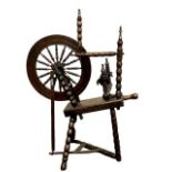 A nineteenth century elm and stained beech spinning wheel, height 102 cm.