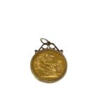 A George V gold sovereign, dated 1912, mounted as a 9ct gold rimmed pendant, 9.2g.