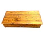 An early twentieth century pine storage box with hinged lid, width 124 cm, depth 61 cm,