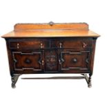 An Edwardian oak sideboard, fitted with two drawers above two cupboard doors, width 152 cm.