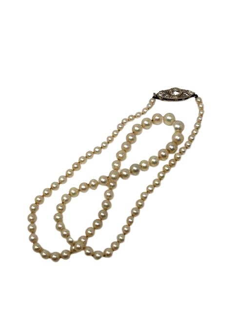 A single strand graduated cultured pearl necklace with diamond set clasp, length 46 cm.