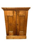 An early twentieth century pine double door cabinet, the panels marked 'H De Cabanas' , width 46 cm.