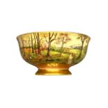 A Royal Doulton hand painted and gilded fruit bowl decorated with a figure in a forest,