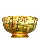 A Royal Doulton hand painted and gilded fruit bowl decorated with a figure in a forest,