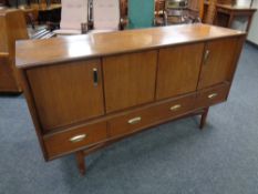 A 20th century teak low sideboard fitted cupboards and drawers