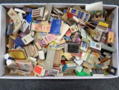 A box of vintage match books and match boxes
