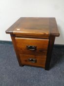 A stained pine two drawer bedside chest