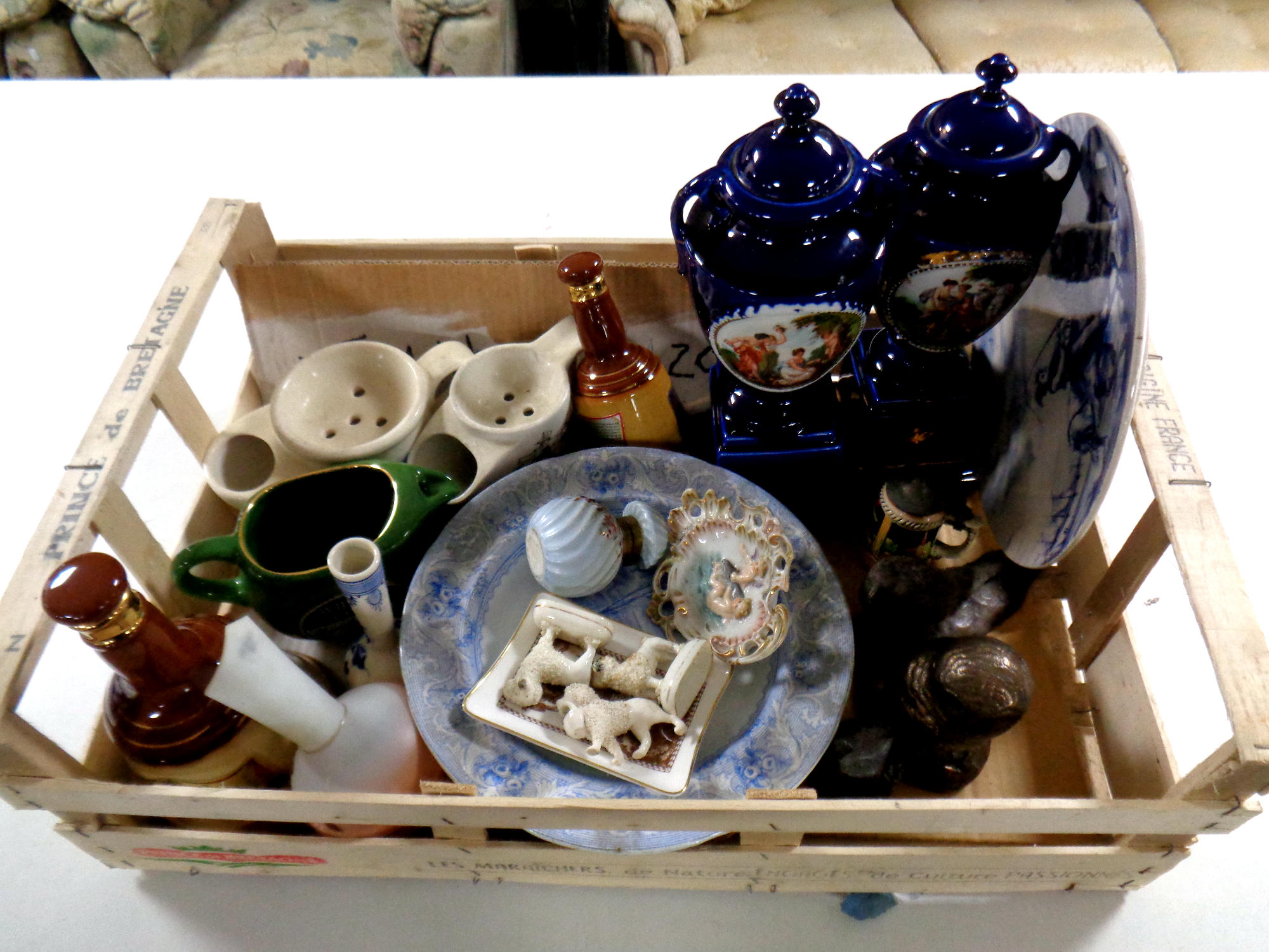 A box of assorted ceramics to include Wade Bells Whiskey decanters, miniature Staffordshire dogs,